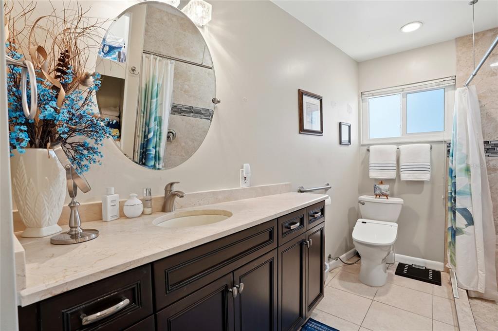 6641 12th Avenue North St. Petersburg, FL 33710 - Photo 11 of 18 a bathroom with a double vanity sink and a toilet