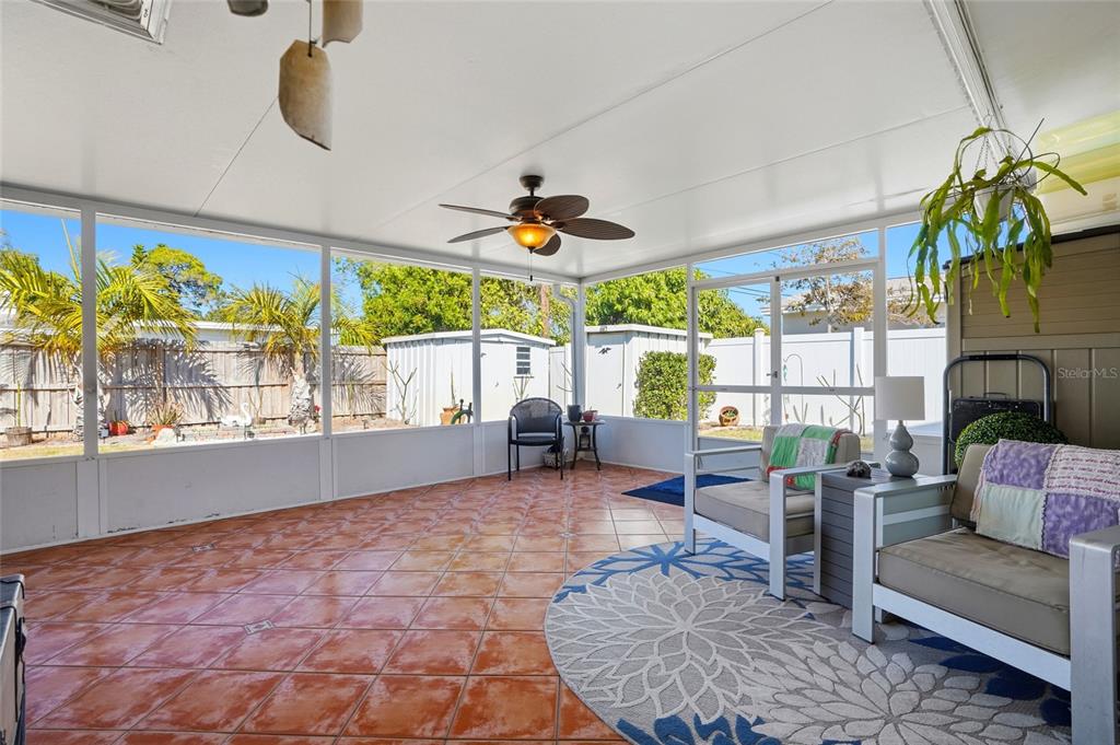 6641 12th Avenue North St. Petersburg, FL 33710 - Photo 13 of 18 a living room with furniture a floor to ceiling window and a rug