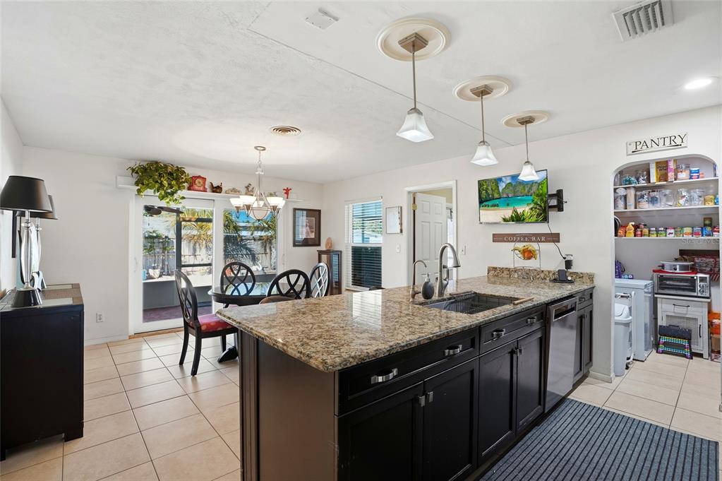 6641 12th Avenue North St. Petersburg, FL 33710 - Photo 5 of 18 a kitchen with stainless steel appliances granite countertop stove top oven and cabinets
