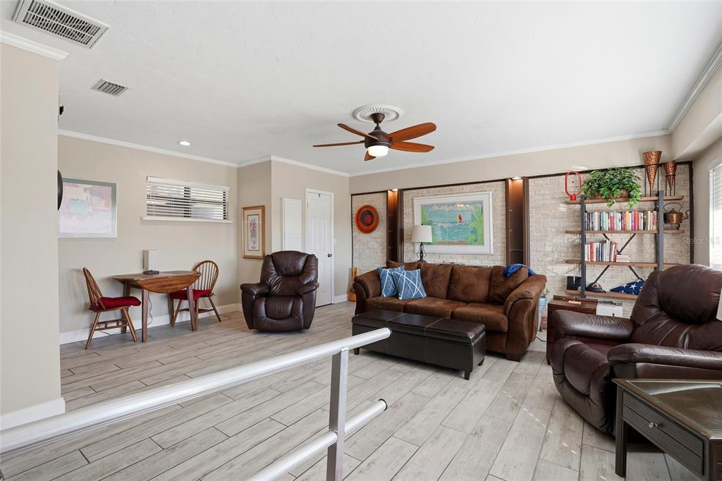 6641 12th Avenue North St. Petersburg, FL 33710 - Photo 8 of 18 a living room with furniture two window and a flat screen tv