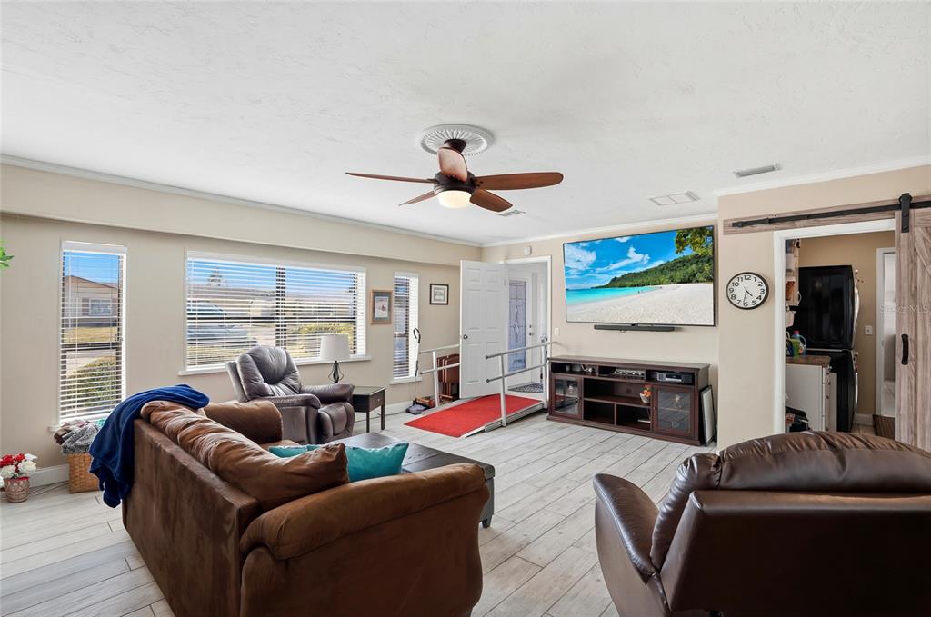 6641 12th Avenue North St. Petersburg, FL 33710 - Photo 9 of 18 a living room with furniture and a flat screen tv