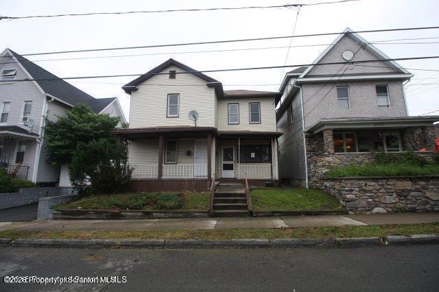 2031 Delaware Street, Unit 2 Dunmore, PA 18512 - Photo 2 of 10 a front view of a house with a yard and garage
