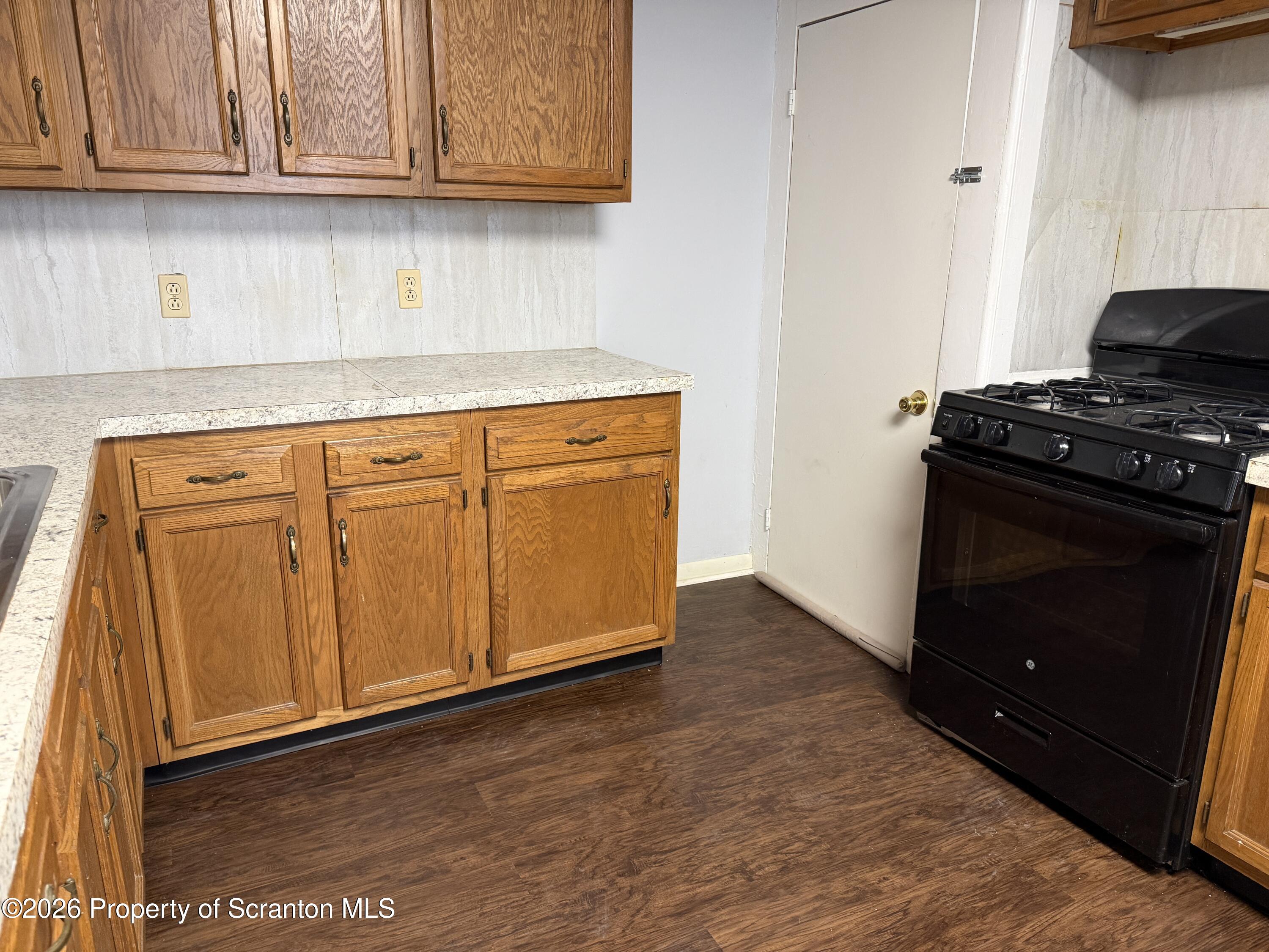 2031 Delaware Street, Unit 2 Dunmore, PA 18512 - Photo 3 of 10 a kitchen with granite countertop cabinets and black appliances