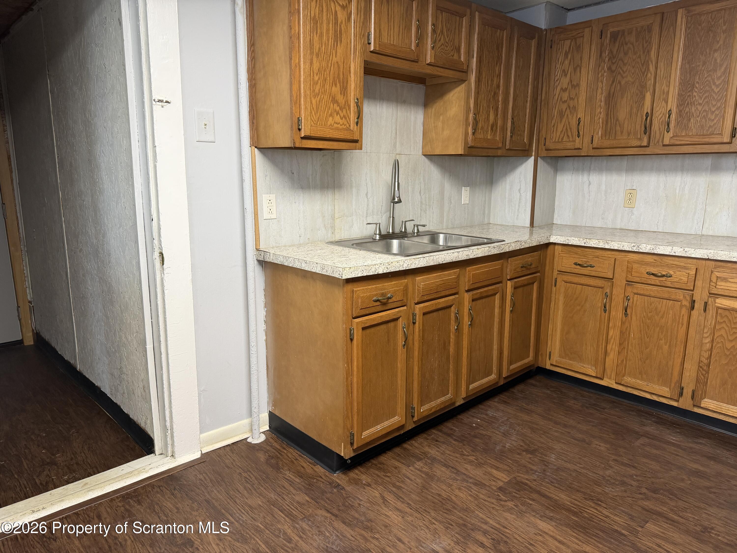 2031 Delaware Street, Unit 2 Dunmore, PA 18512 - Photo 4 of 10 a kitchen with granite countertop wooden cabinets a sink and dishwasher