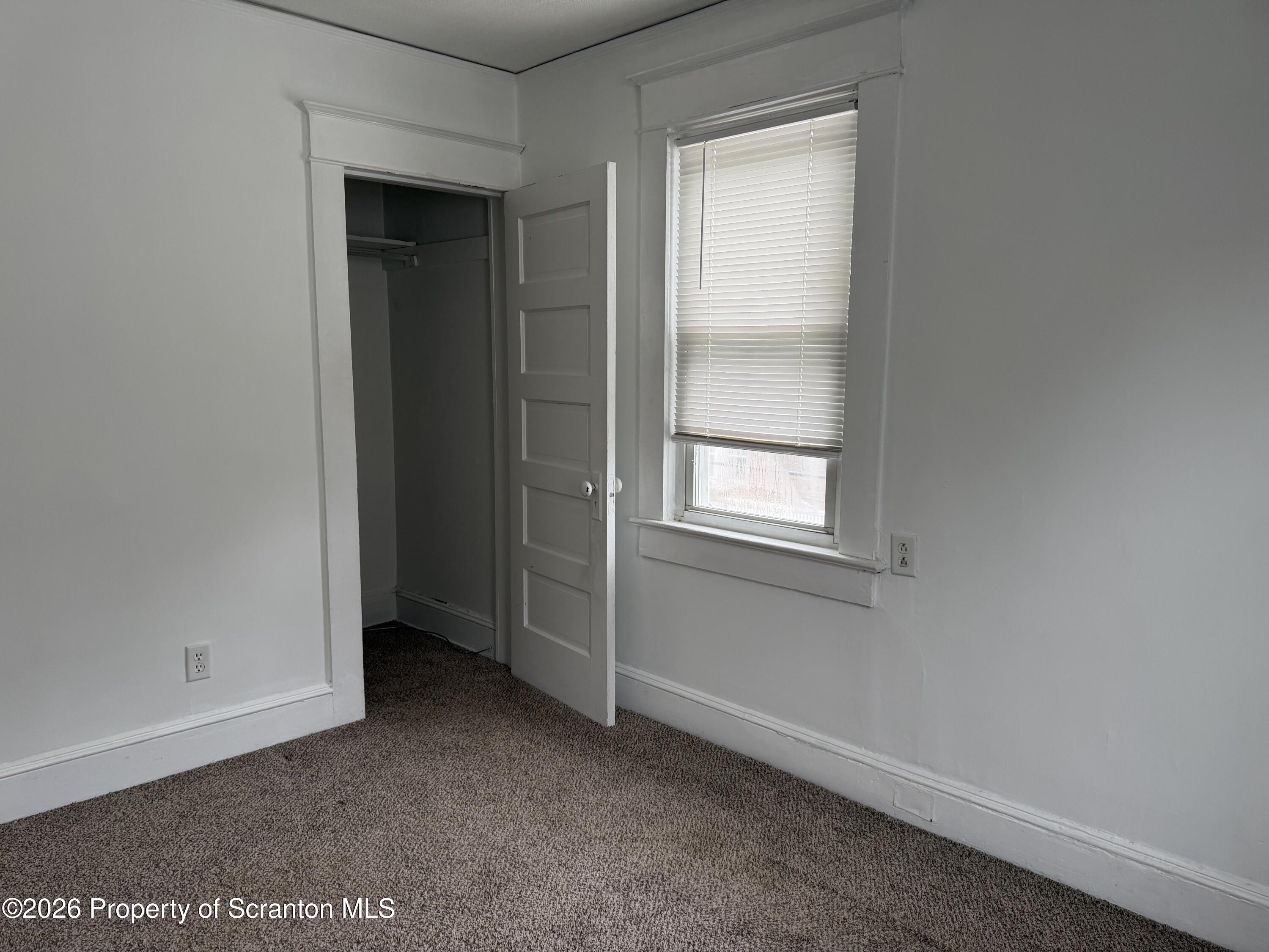 2031 Delaware Street, Unit 2 Dunmore, PA 18512 - Photo 5 of 10 an empty room with windows