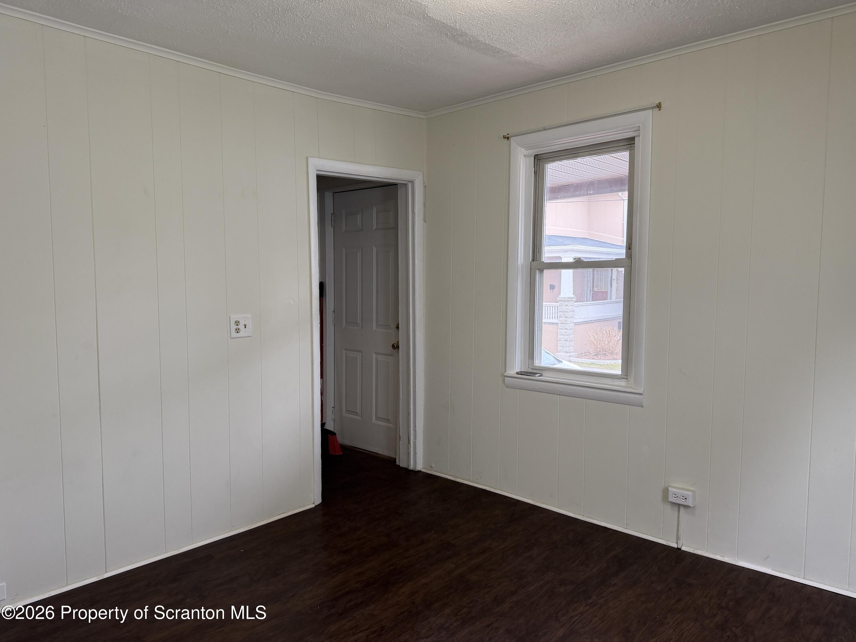 2031 Delaware Street, Unit 2 Dunmore, PA 18512 - Photo 7 of 10 an empty room with wooden floor and windows