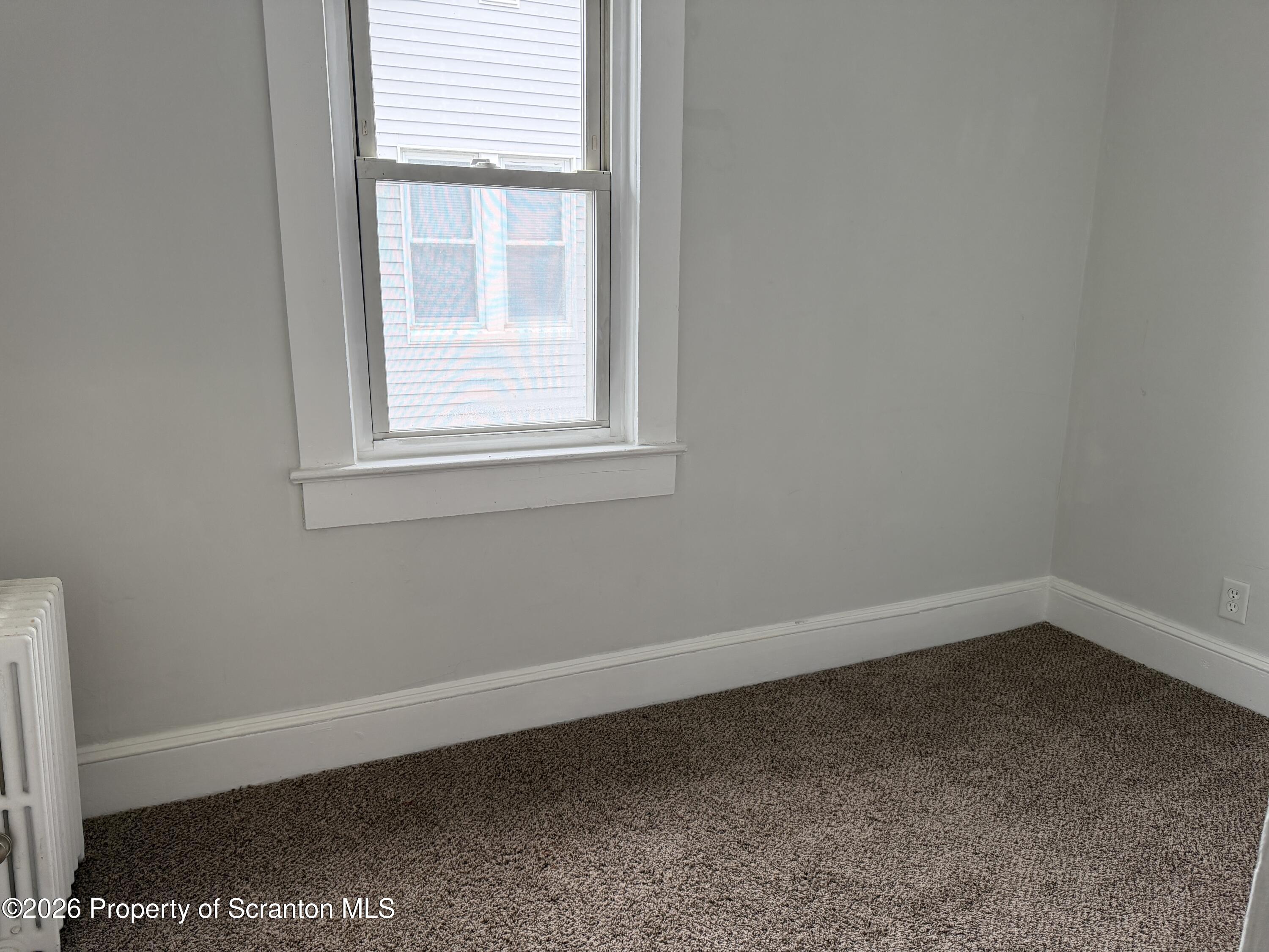 2031 Delaware Street, Unit 2 Dunmore, PA 18512 - Photo 8 of 10 an empty room with a window