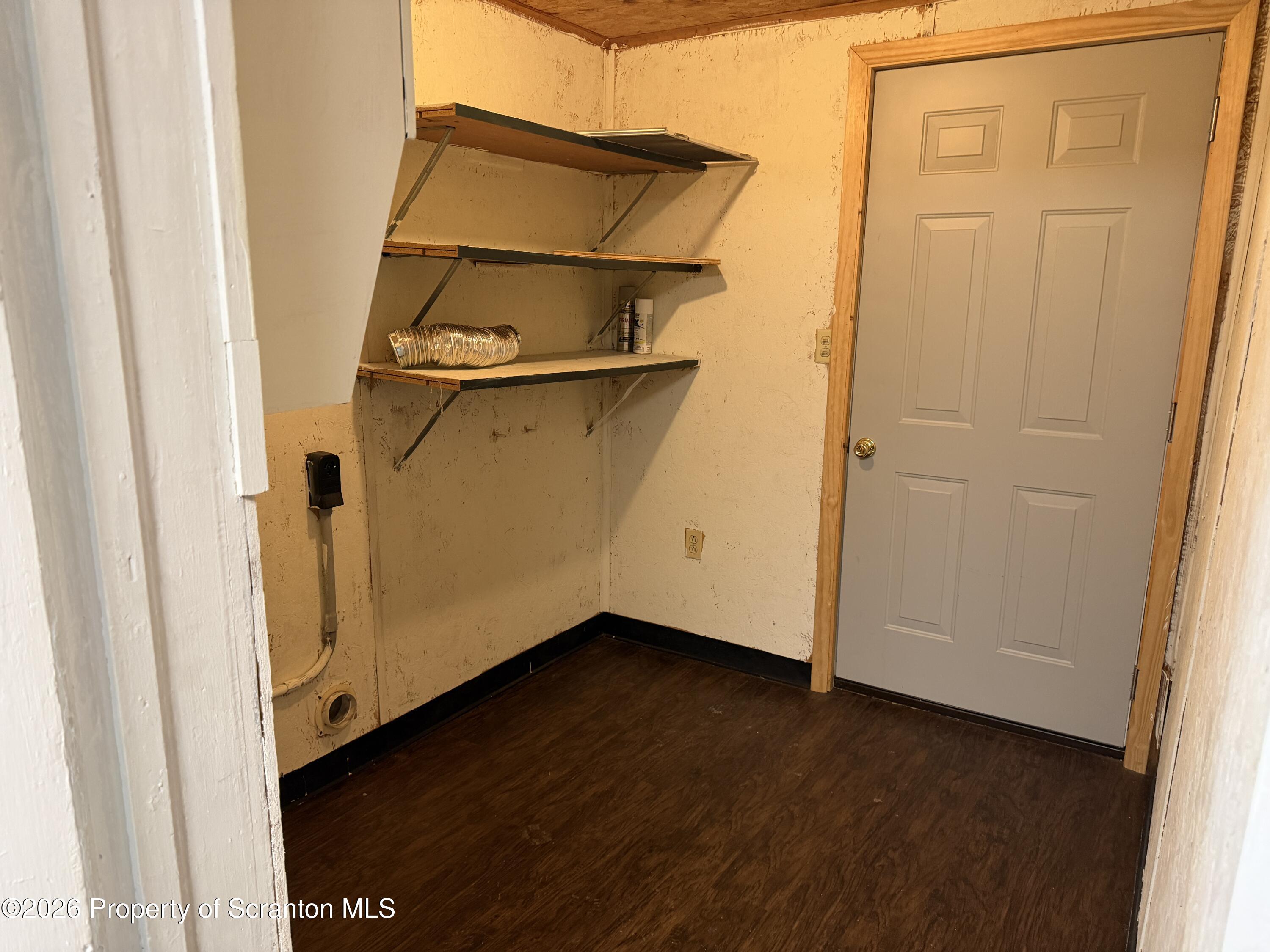 2031 Delaware Street, Unit 2 Dunmore, PA 18512 - Photo 10 of 10 an empty room with wooden floor and cabinet