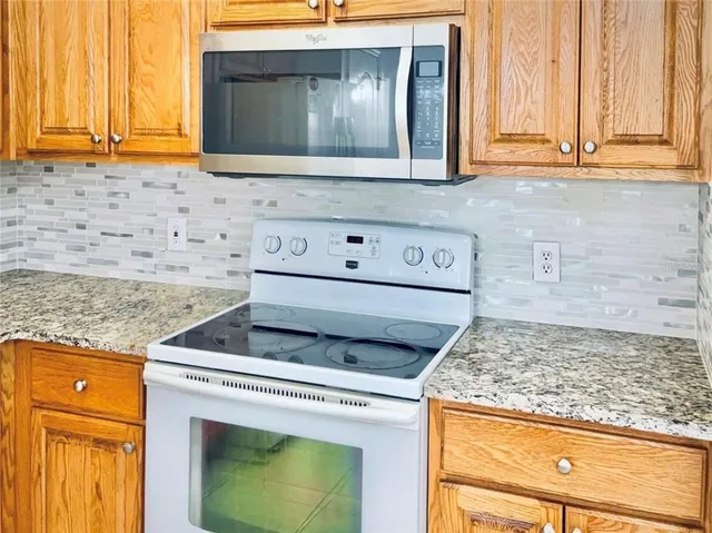 a stove top oven sitting inside of a kitchen