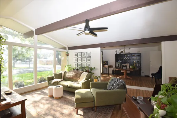 a living room with furniture and a large window with garden view