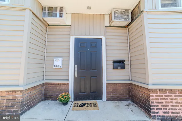 a view of a door and chair front of house
