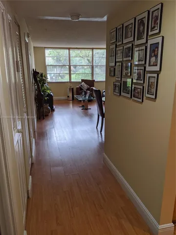 a livingroom with furniture hardwood floor and a window