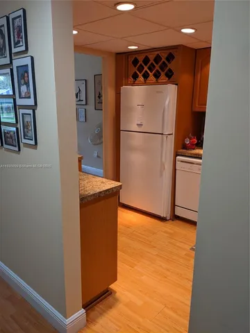 a kitchen with stainless steel appliances granite countertop a refrigerator and a sink