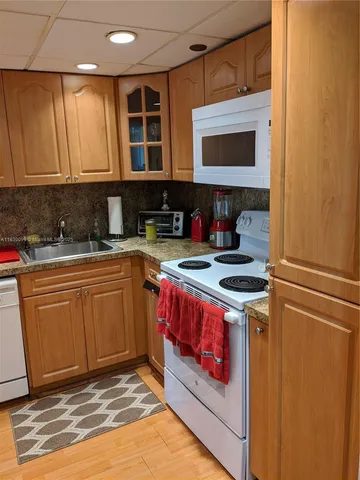a kitchen with stainless steel appliances granite countertop a stove and a sink