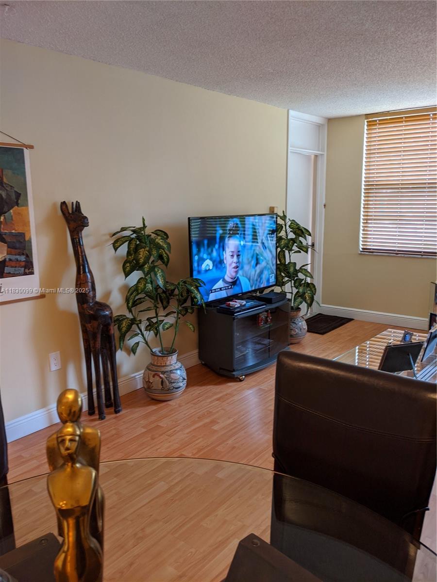 900 St Charles Place, Unit L6 Pembroke Pines, FL 33026 - Photo 9 of 10 a living room with furniture and a flat screen tv