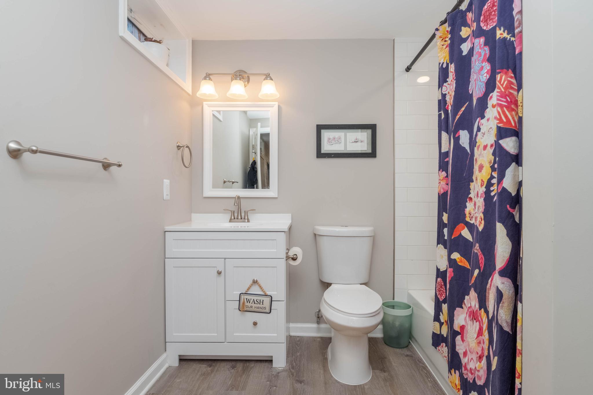 1522 Southview Road Bel Air, MD 21015 - Photo 35 of 42 a bathroom with a toilet sink and mirror