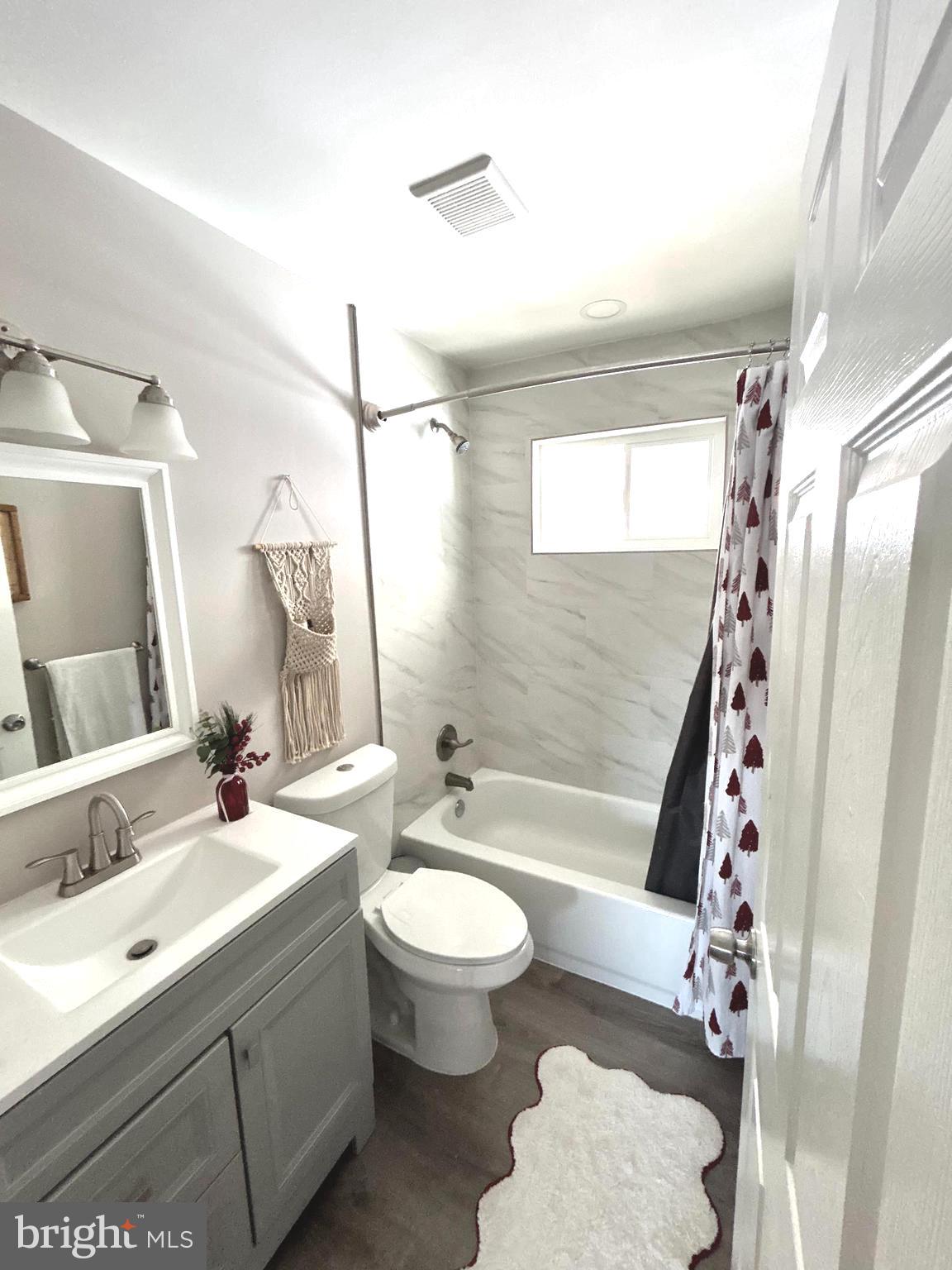 1522 Southview Road Bel Air, MD 21015 - Photo 4 of 7 a bathroom with a sink a toilet a mirror a bathtub and shower