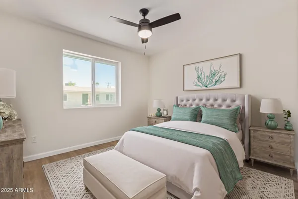 a bedroom with a bed and a painting on the wall