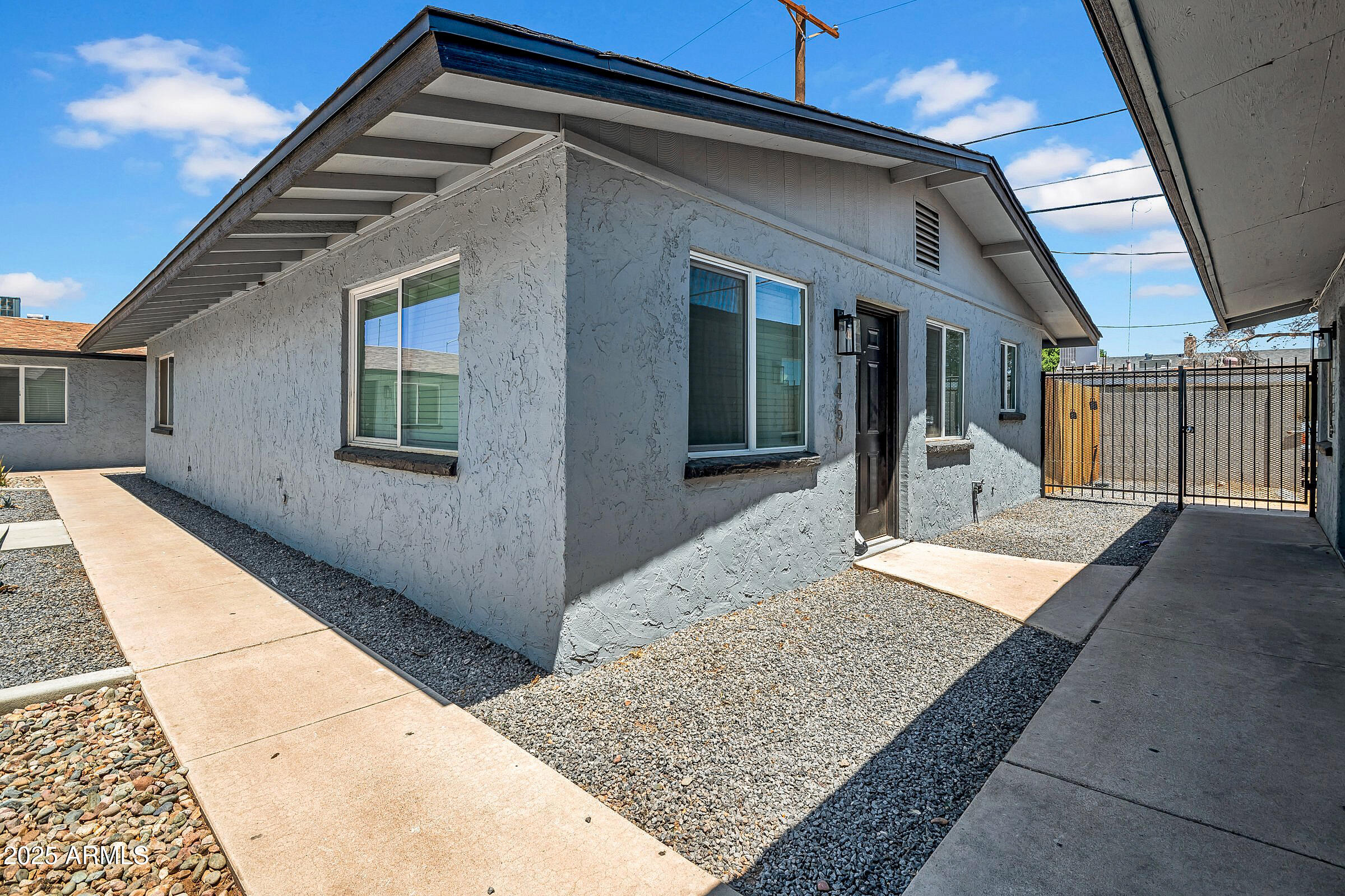 1432 East Broadway Road Mesa, AZ 85204 - Photo 2 of 13 front view of a house with a glass door