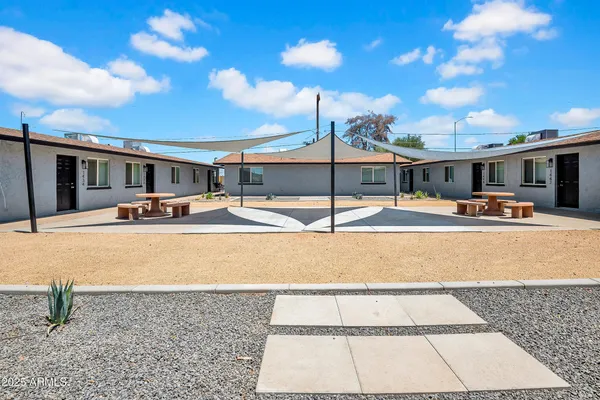 a swimming pool with outdoor seating and yard in the back