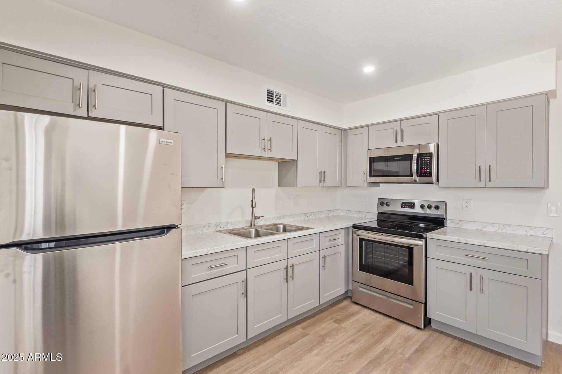 1432 East Broadway Road Mesa, AZ 85204 - Photo 7 of 13 a kitchen with white cabinets sink and white appliances