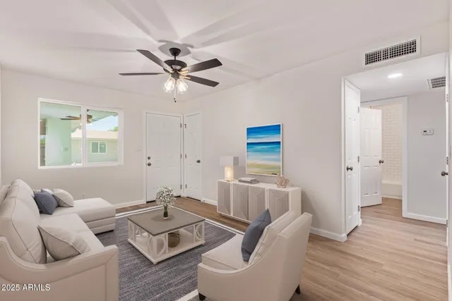 a living room with furniture and a wooden floor