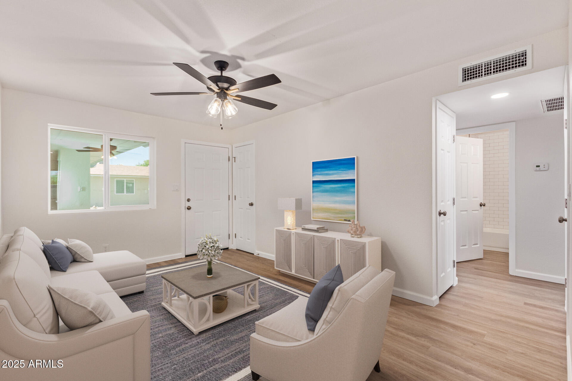 1432 East Broadway Road Mesa, AZ 85204 - Photo 8 of 13 a living room with furniture and a wooden floor