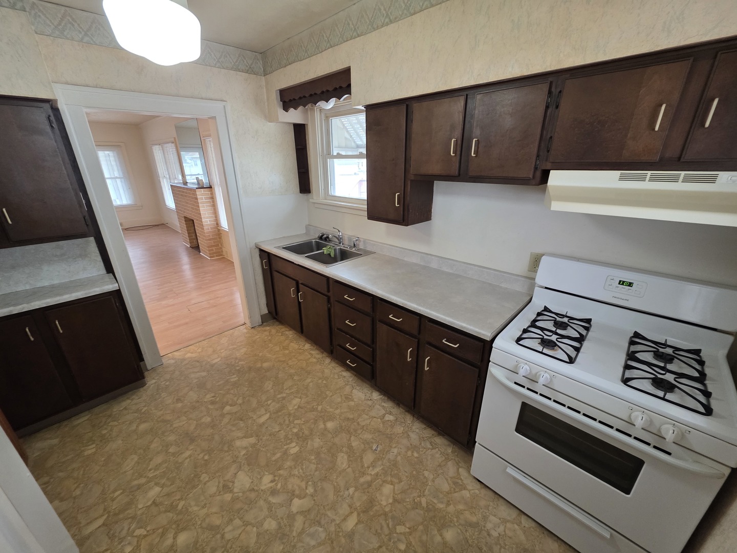 312 East 11th Street Sterling, IL 61081 - Photo 13 of 21 a kitchen with a stove and a microwave