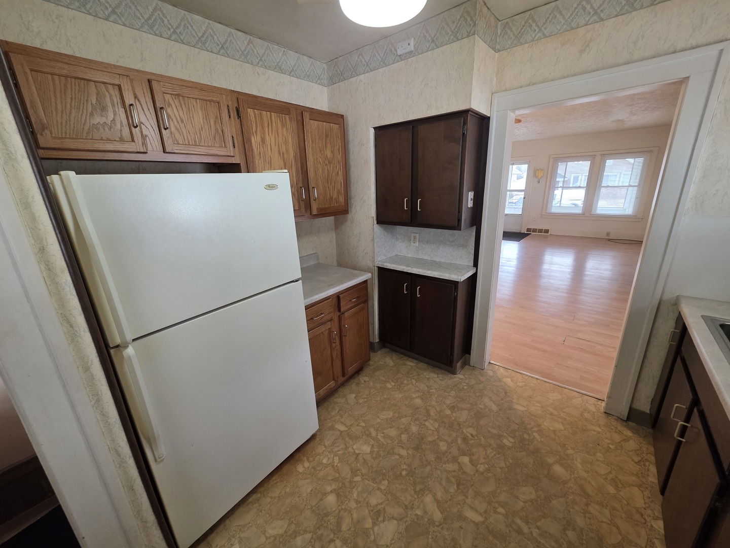 312 East 11th Street Sterling, IL 61081 - Photo 14 of 21 a white refrigerator freezer and a stove sitting inside of a kitchen