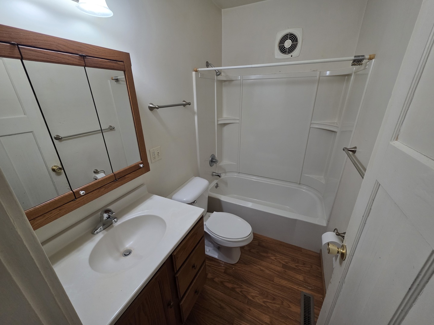 312 East 11th Street Sterling, IL 61081 - Photo 6 of 21 a bathroom with a sink a toilet a mirror and shower