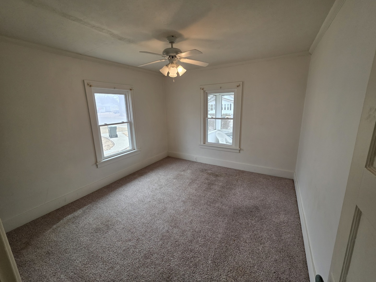 312 East 11th Street Sterling, IL 61081 - Photo 7 of 21 an empty room with windows and fan
