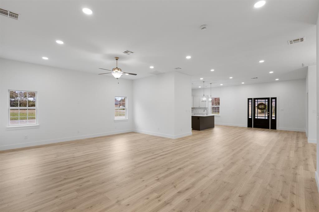 1812 Carpenter Street Bridgeport, TX 76426 - Photo 17 of 30 a view of an empty room with a kitchen and a window