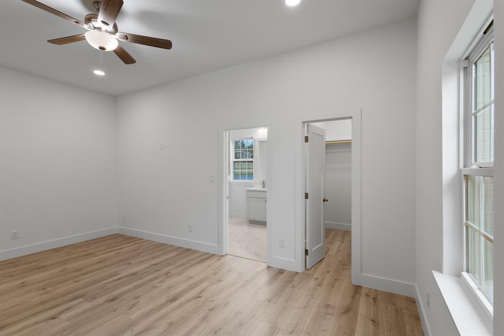 1812 Carpenter Street Bridgeport, TX 76426 - Photo 22 of 30 wooden floor in an empty room with a window