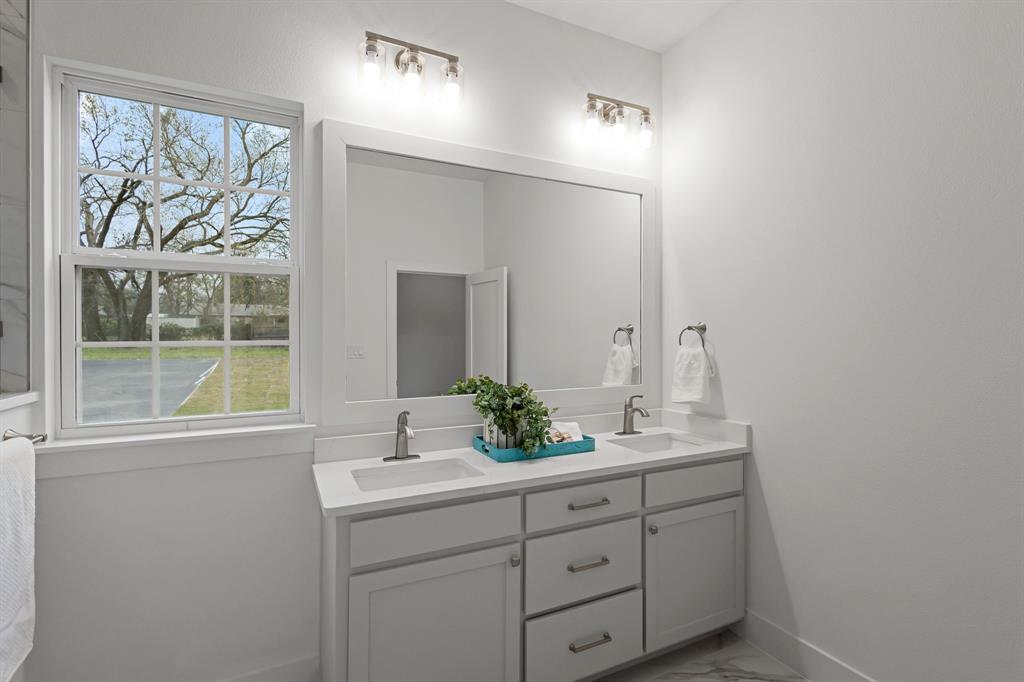 1812 Carpenter Street Bridgeport, TX 76426 - Photo 25 of 30 a bathroom with a sink and mirror with window