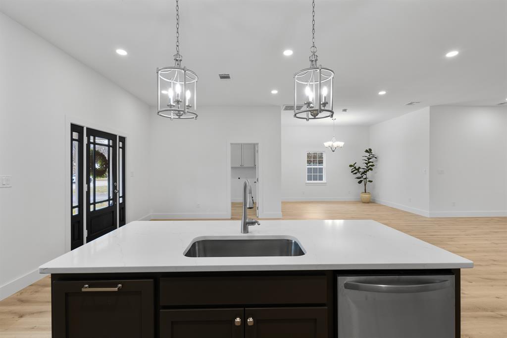 1812 Carpenter Street Bridgeport, TX 76426 - Photo 8 of 30 a view of a dining room with a sink and chandelier