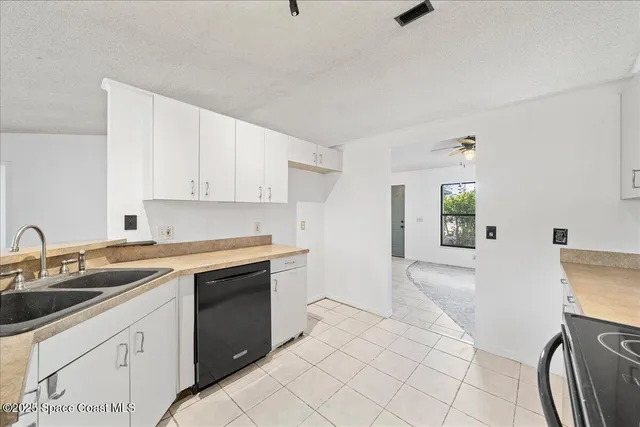 a kitchen with a sink cabinets and appliances