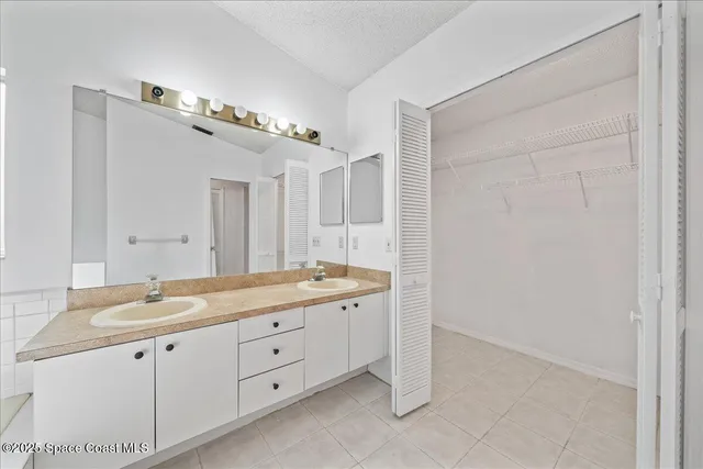 a spacious bathroom with a granite countertop sink mirror and