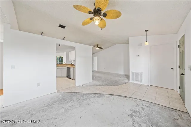a view of a kitchen with wooden cabinet and a ceiling fan