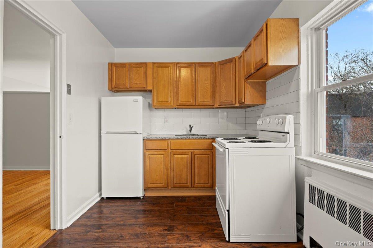 437 Pelham Road, Unit B2 New Rochelle, NY 10805 - Photo 11 of 17 a kitchen with a refrigerator sink and cabinets