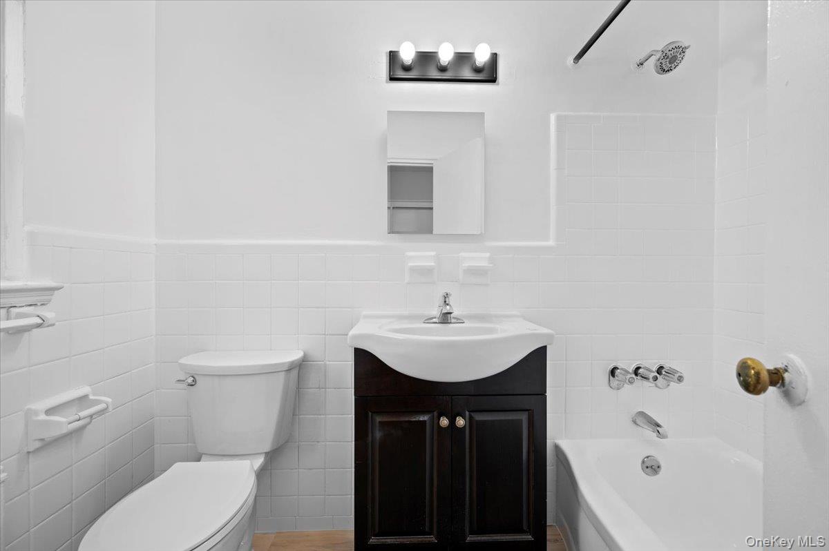 437 Pelham Road, Unit B2 New Rochelle, NY 10805 - Photo 14 of 17 a bathroom with a sink a toilet and shower