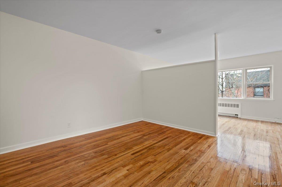 437 Pelham Road, Unit B2 New Rochelle, NY 10805 - Photo 6 of 17 a view of empty room with wooden floor and fan