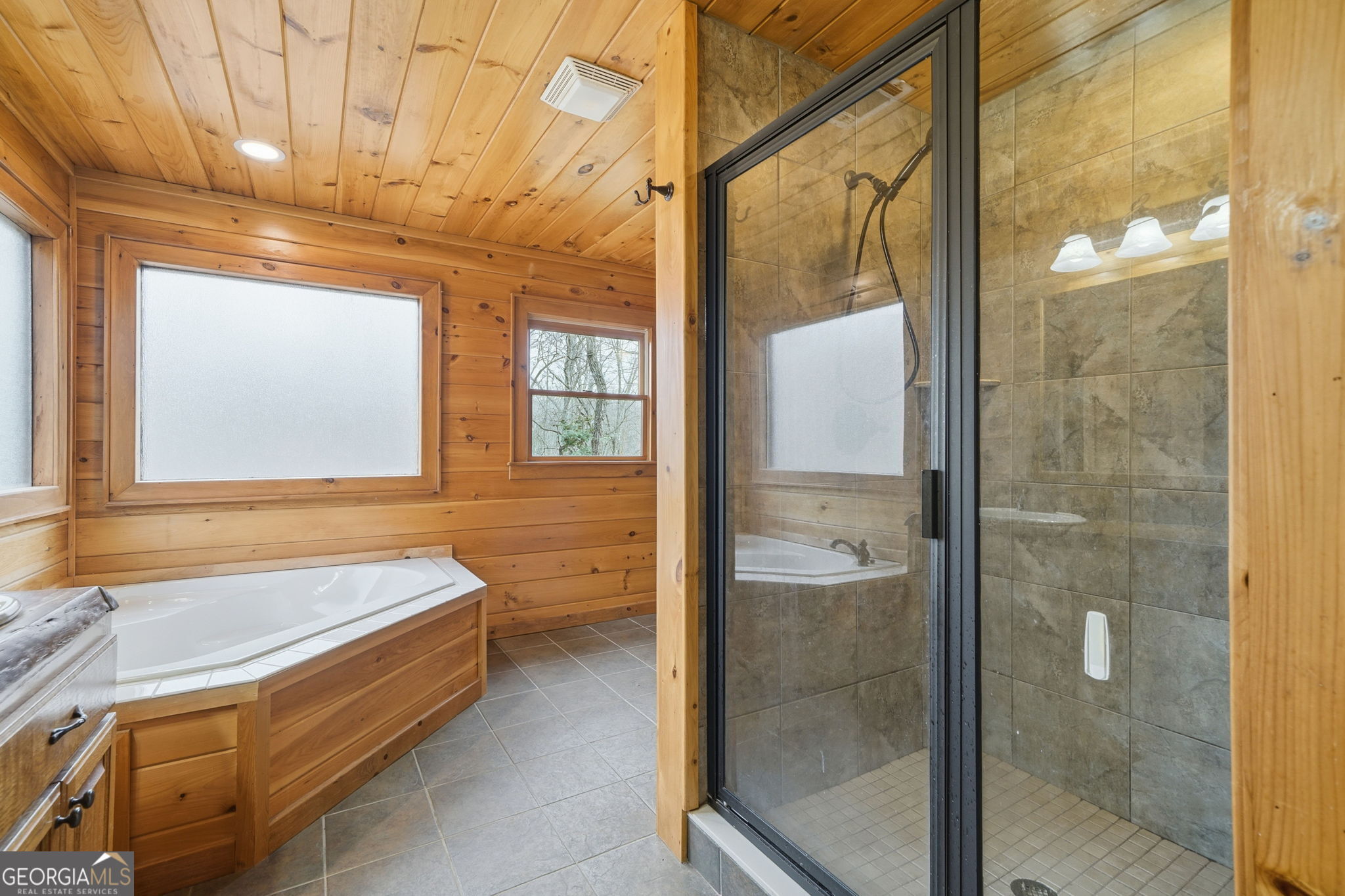 648 Stuart Mountain Road Mineral Bluff, GA 30559 - Photo 18 of 42 a bathroom with a bathtub and a shower