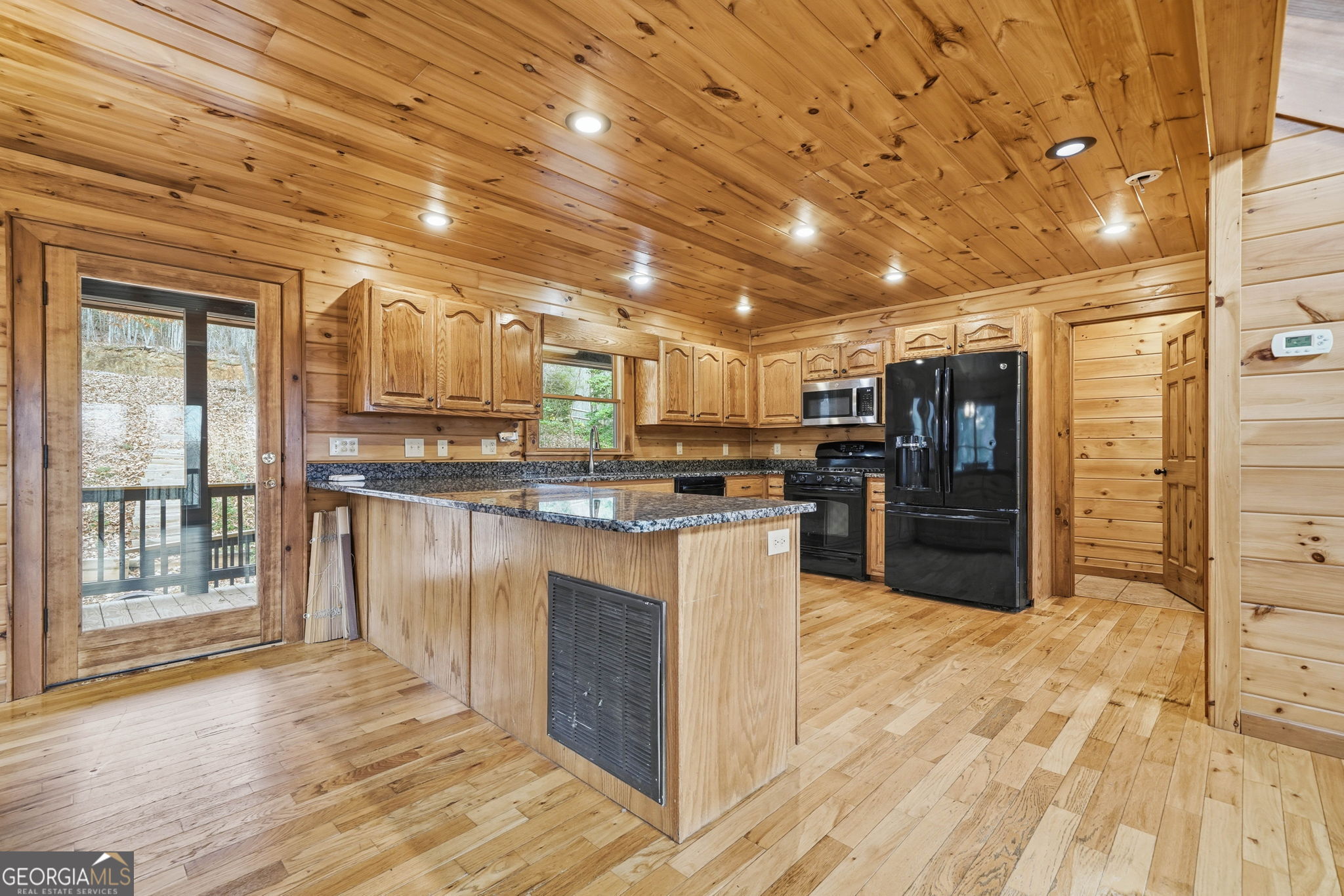 648 Stuart Mountain Road Mineral Bluff, GA 30559 - Photo 2 of 42 a kitchen with stainless steel appliances kitchen island granite countertop a refrigerator and cabinets