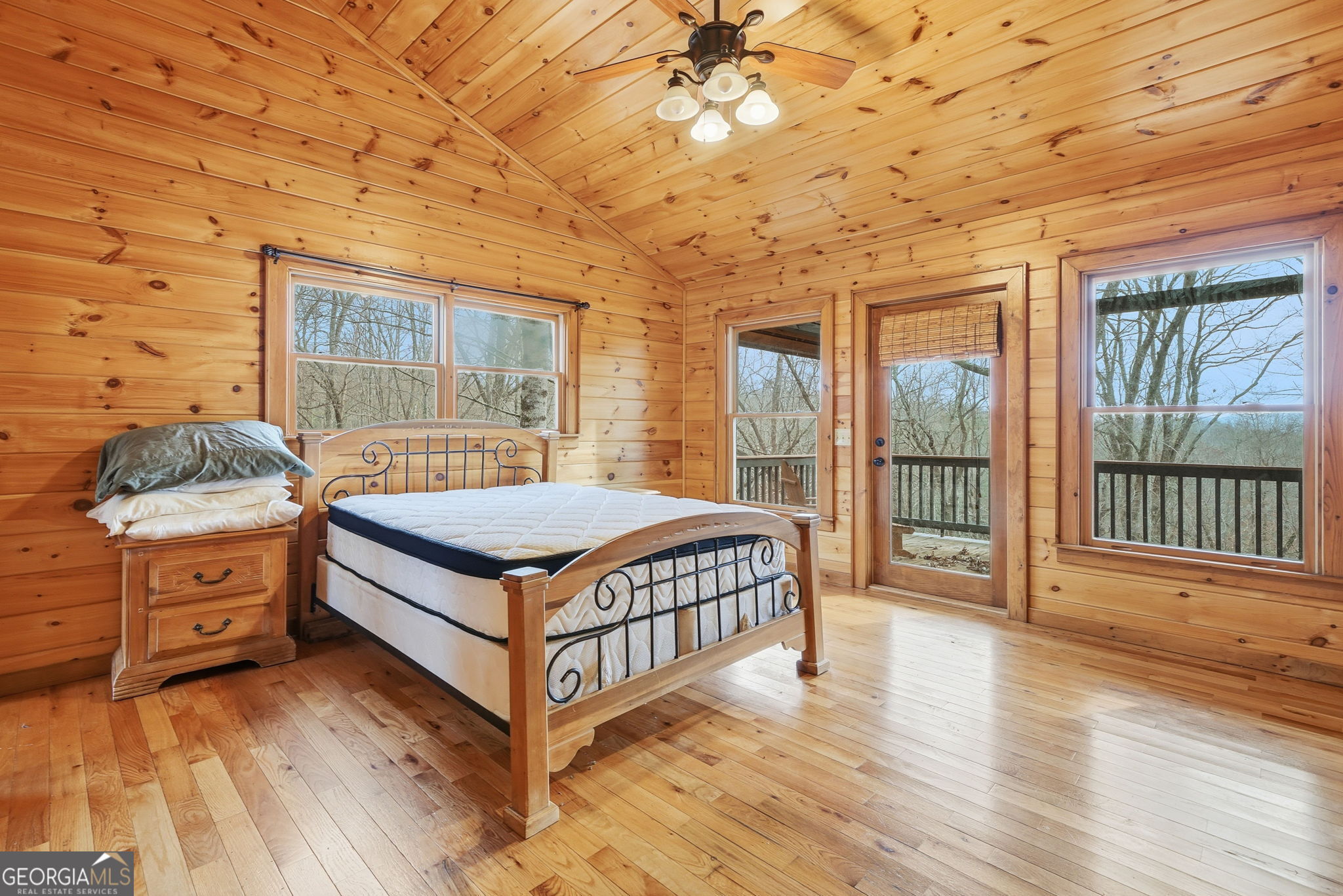 648 Stuart Mountain Road Mineral Bluff, GA 30559 - Photo 21 of 42 a bedroom with a bed and wooden floor