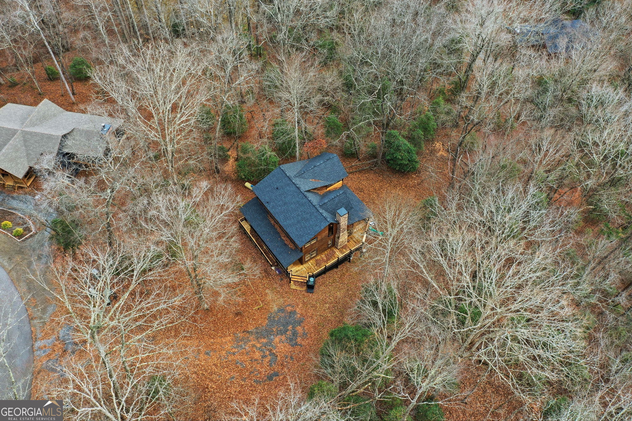 648 Stuart Mountain Road Mineral Bluff, GA 30559 - Photo 37 of 42 a backyard of a house with table and chairs