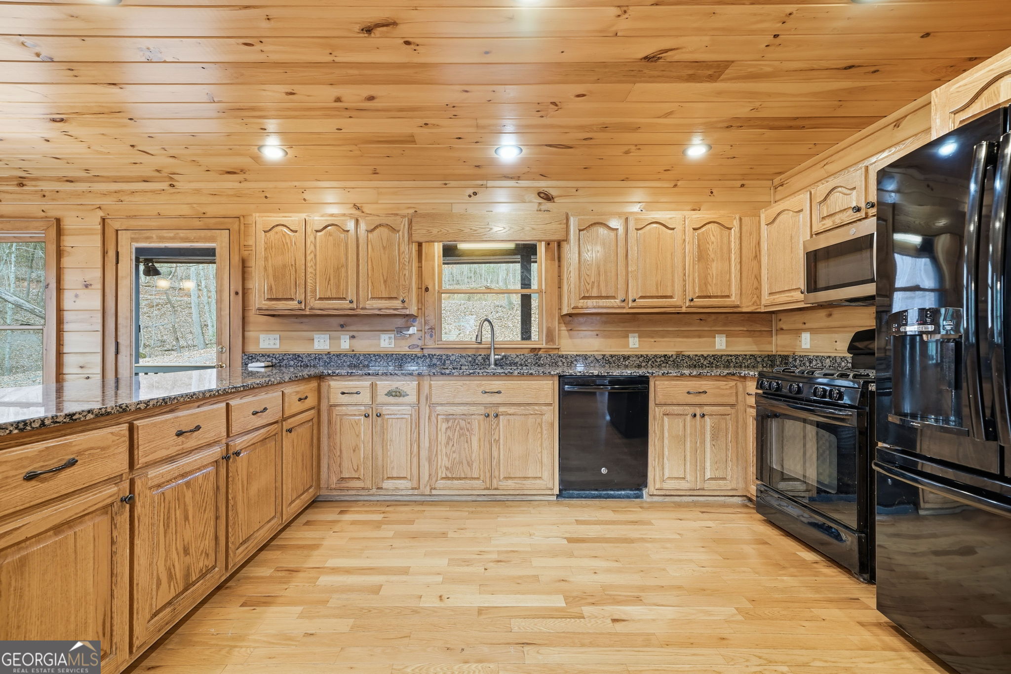 648 Stuart Mountain Road Mineral Bluff, GA 30559 - Photo 6 of 42 a large kitchen with granite countertop a stove top oven a sink dishwasher and cabinets with wooden floor