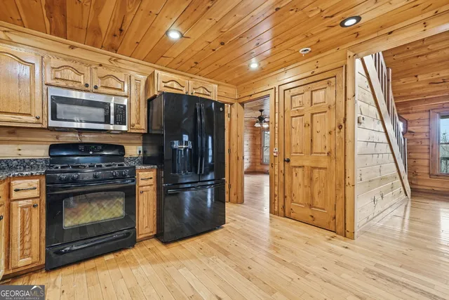 a kitchen with stainless steel appliances granite countertop a refrigerator stove and cabinets