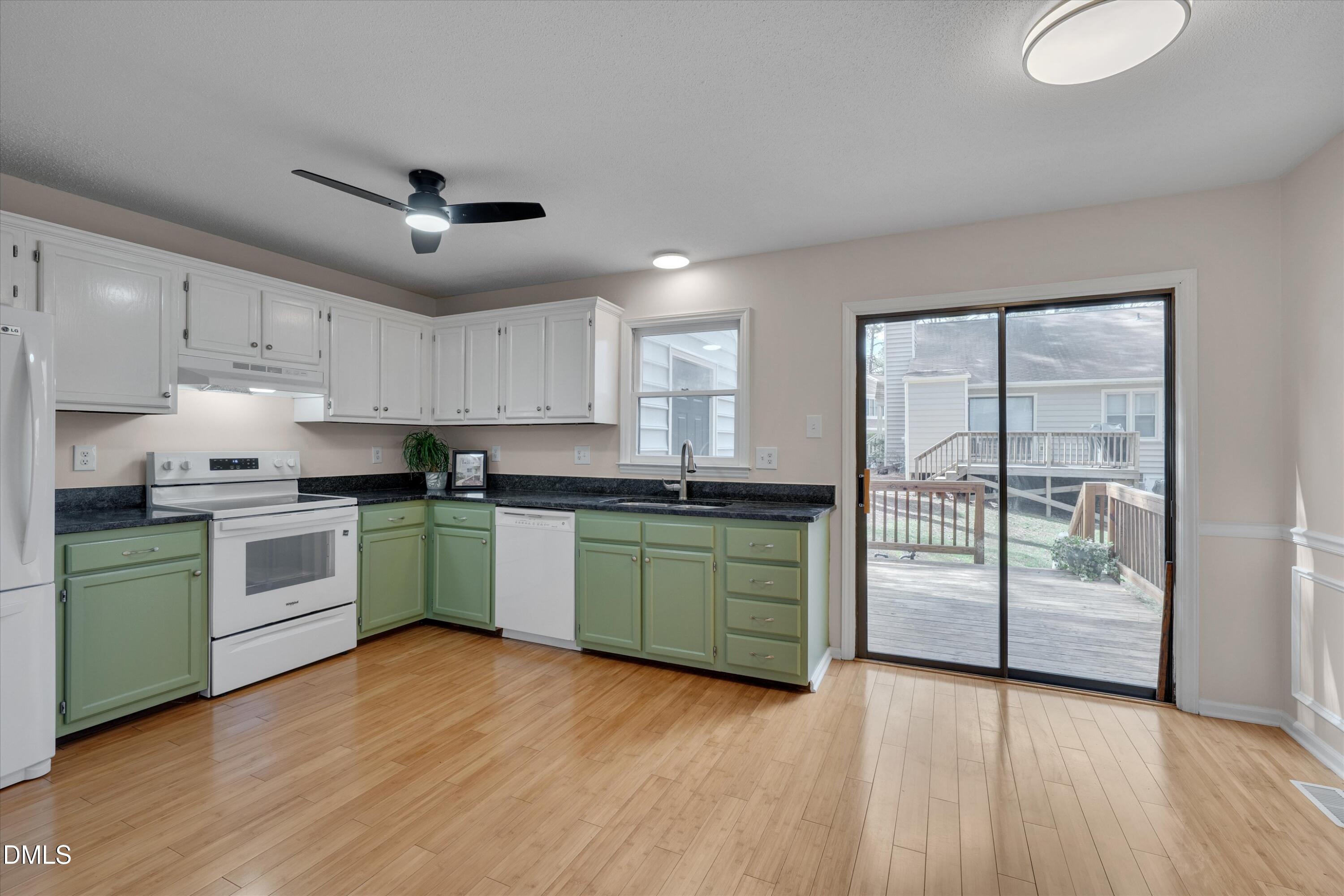 6528 Hearthstone Drive Raleigh, NC 27615 - Photo 10 of 32 a kitchen with granite countertop a stove cabinets and wooden floor