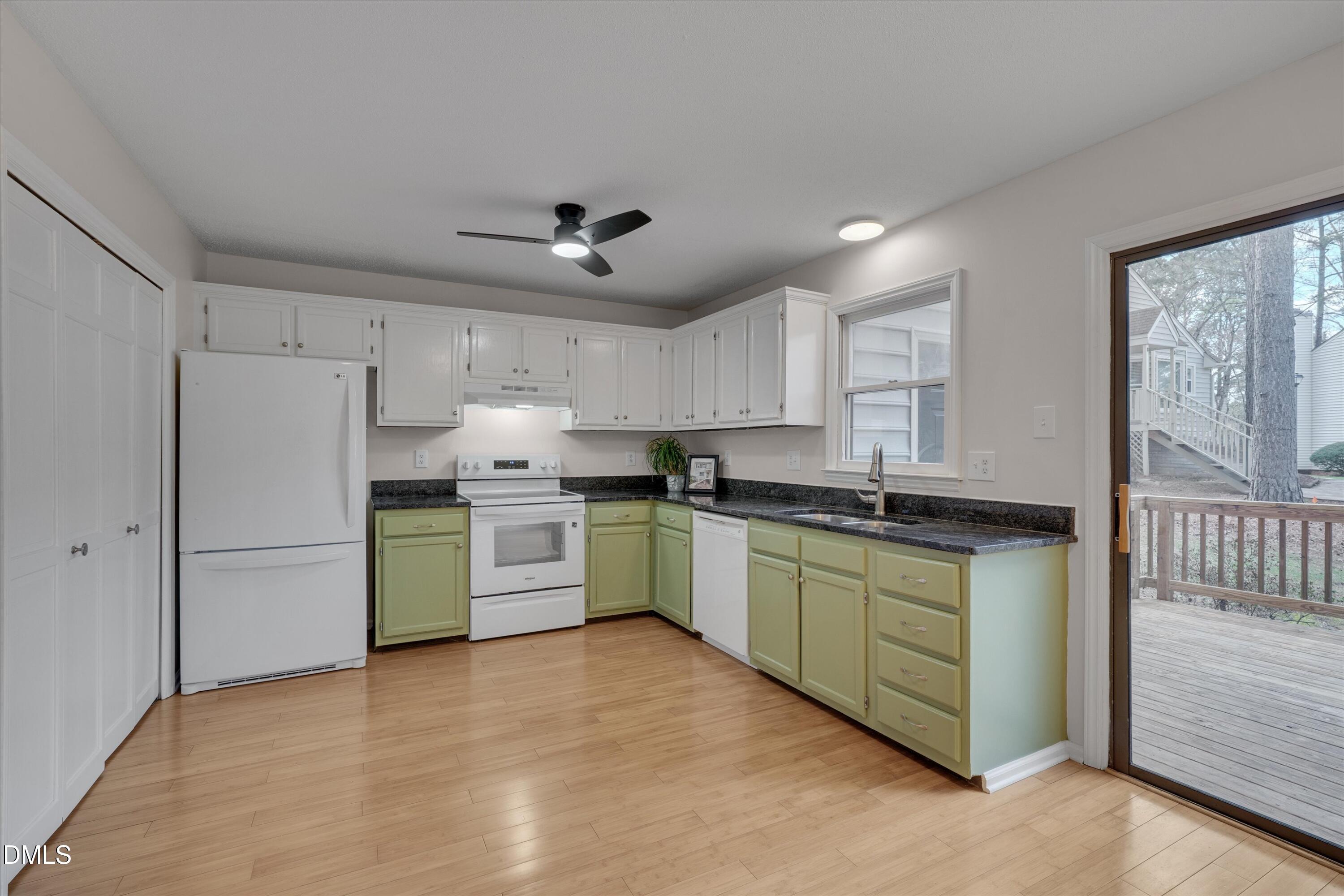 6528 Hearthstone Drive Raleigh, NC 27615 - Photo 12 of 32 a kitchen with a refrigerator and a stove top oven