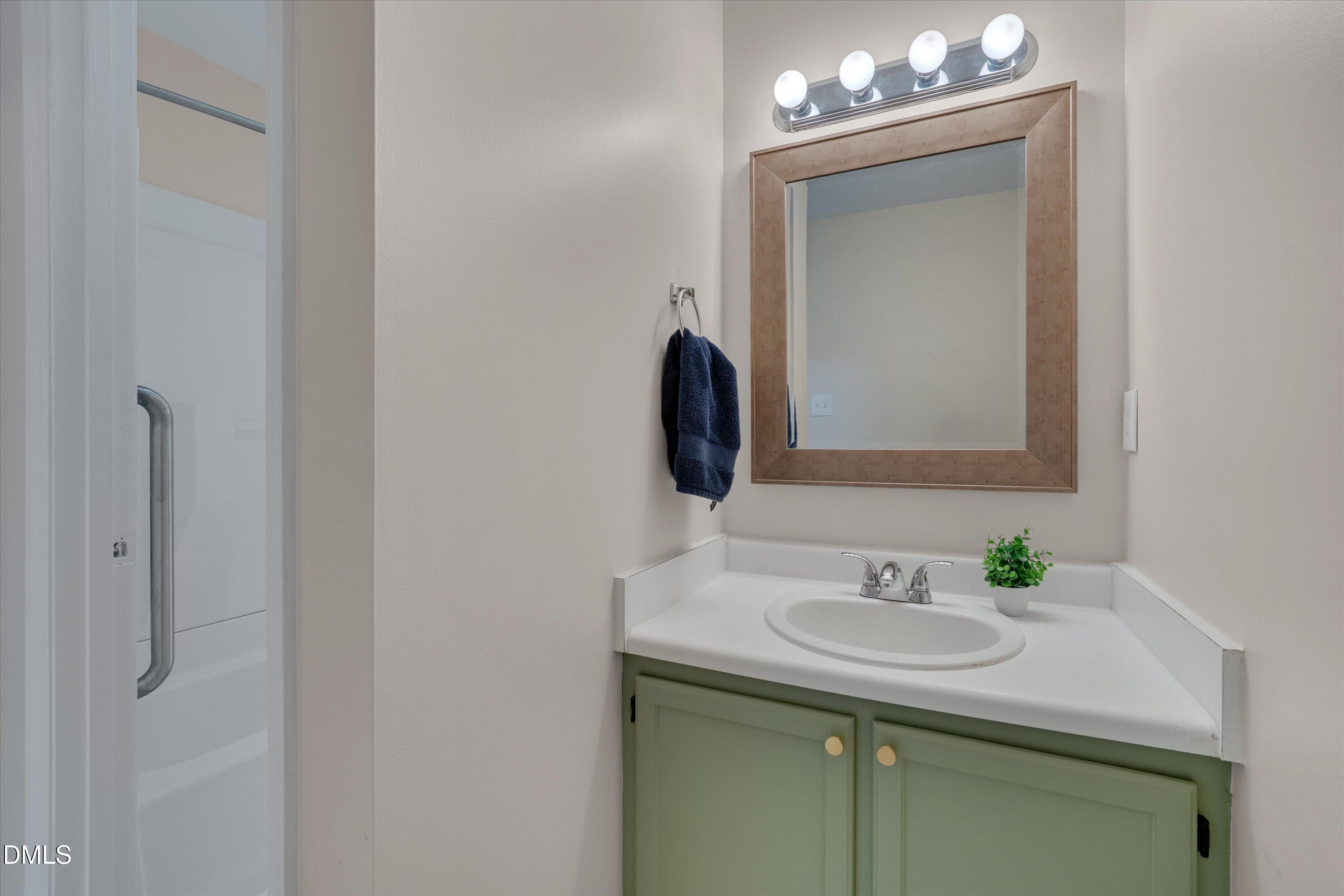 6528 Hearthstone Drive Raleigh, NC 27615 - Photo 18 of 32 a bathroom with a sink and a mirror